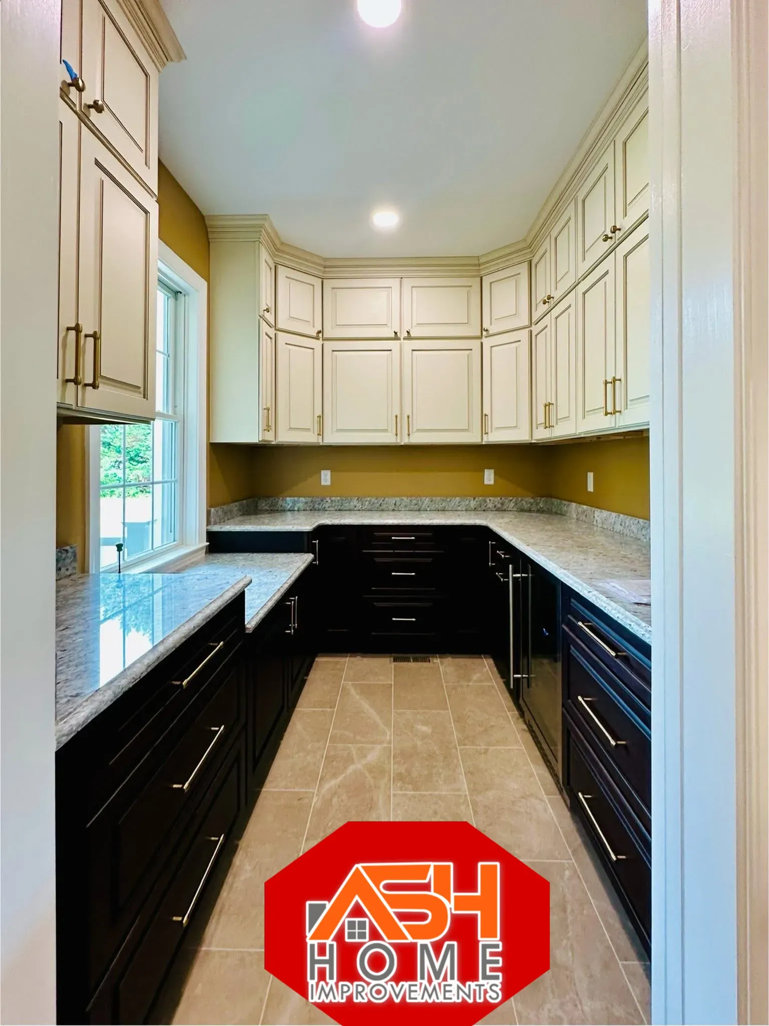 Homeowners consulting with a kitchen remodeling contractor in a remodeled kitchen